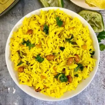 Lemon rice prepared in the instant pot served in a bowl with papad on the side