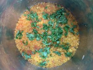 pressure cooked dal tadka garnished with cilantro in the instant pot insert
