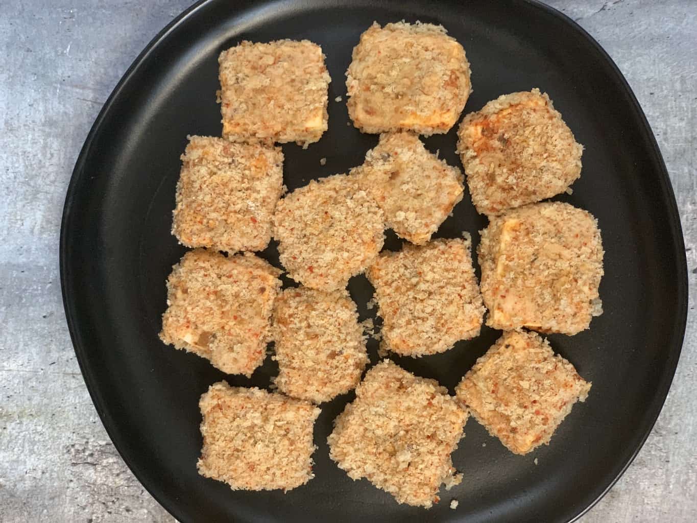 paneer covered with bread crumbs and spices and kept on plate