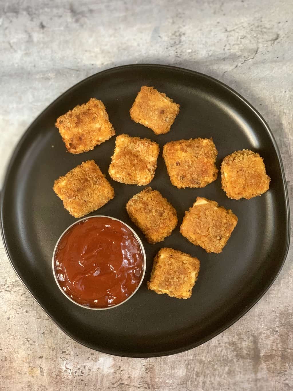 paneer popcorn in a plate with tomato ketchup