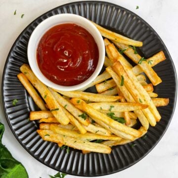 potato french fries recipe made in air frier served on a plate with tomato ketchup