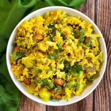 Cauliflower Poha served in a white bowl