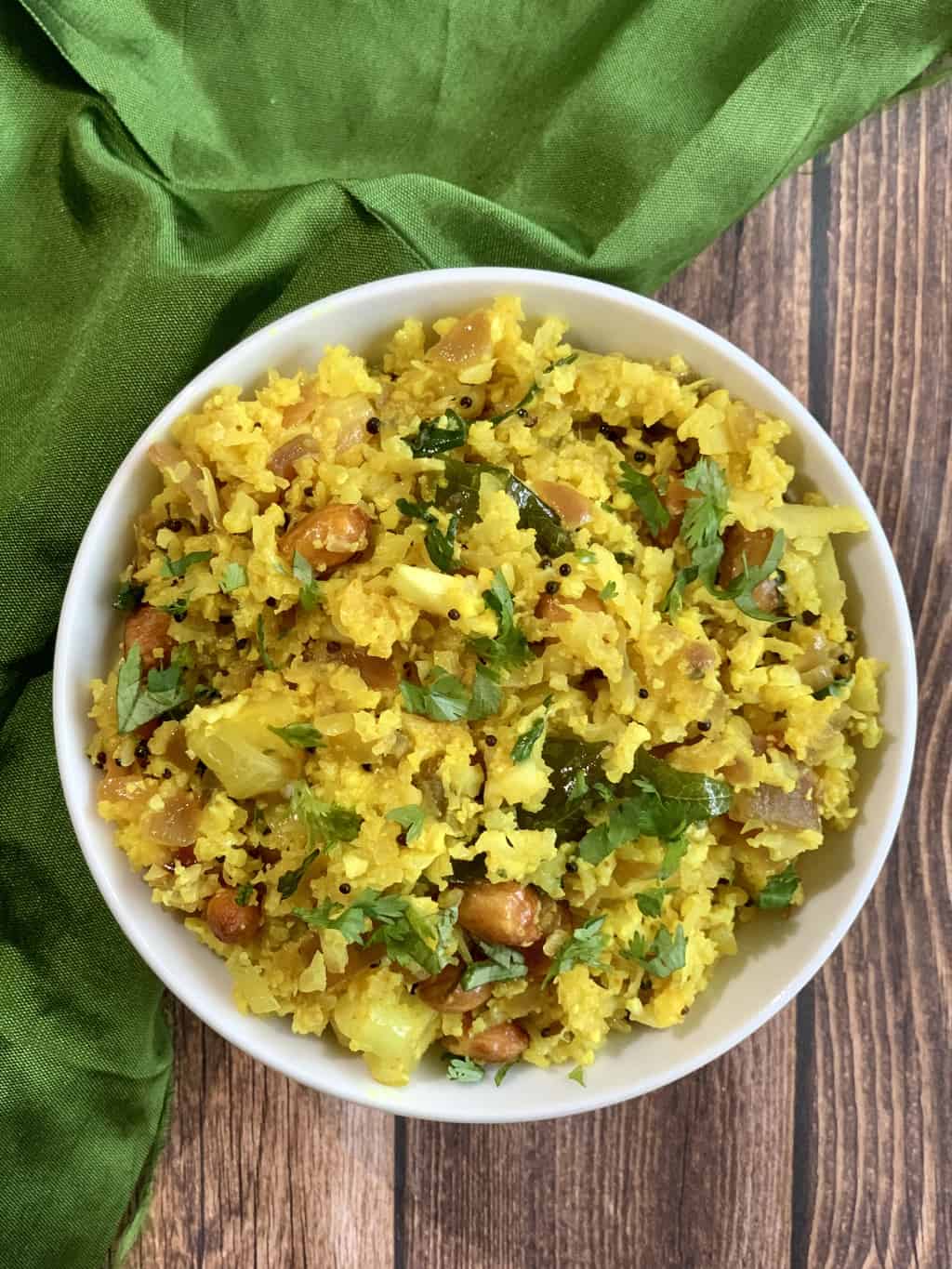 keto cauliflower poha served in a bowl garnished with cilantro