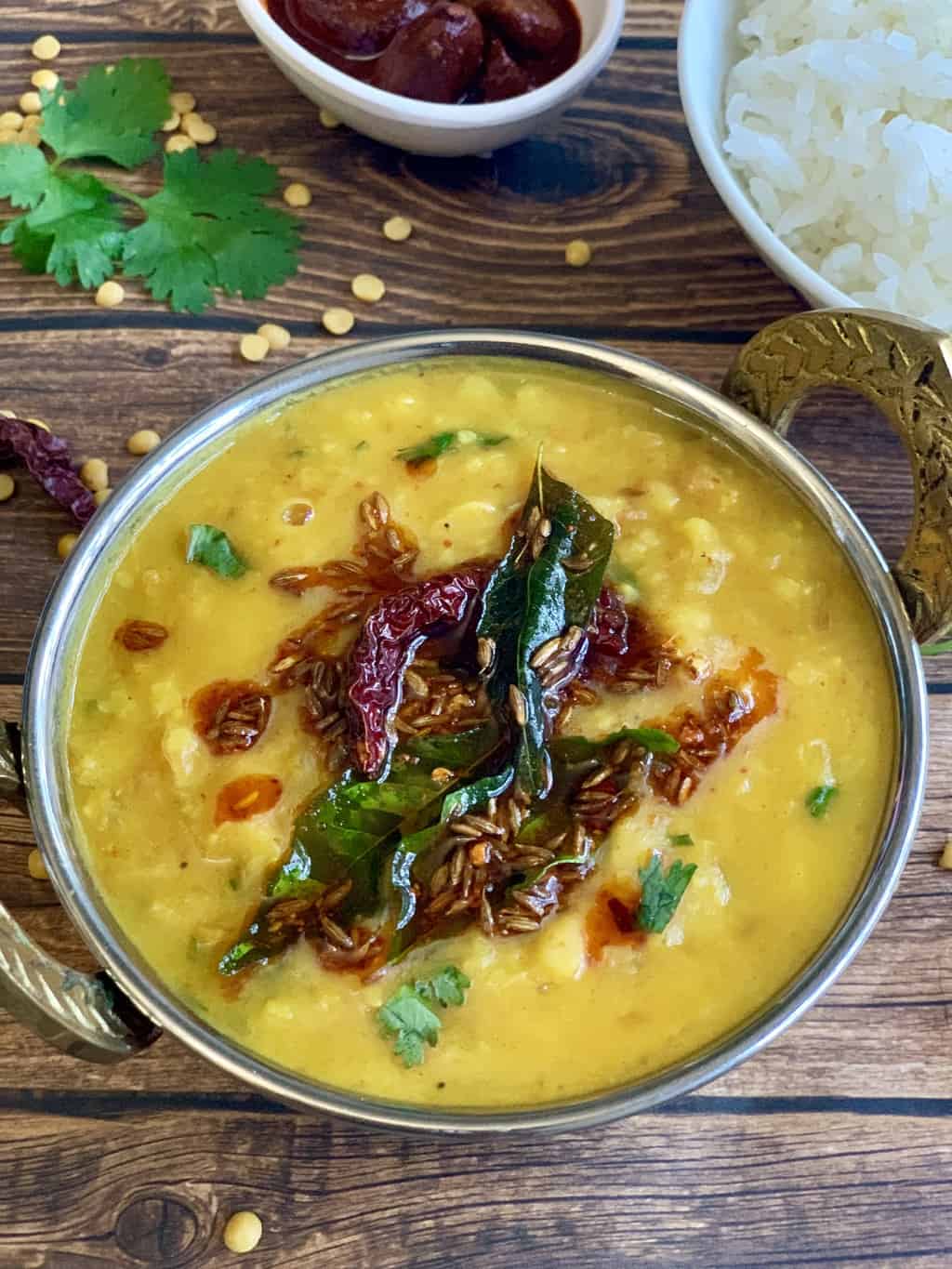 indian dal tadka served in a copper kadai with tempering on top