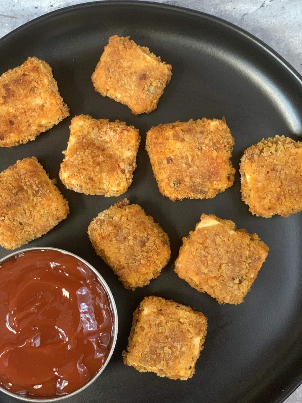 crispy paneer popcorn recipe served on a plate with ketchup on the side