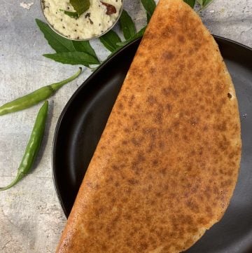 keto almond flour dosa served in a plate with coconut chutney on the side