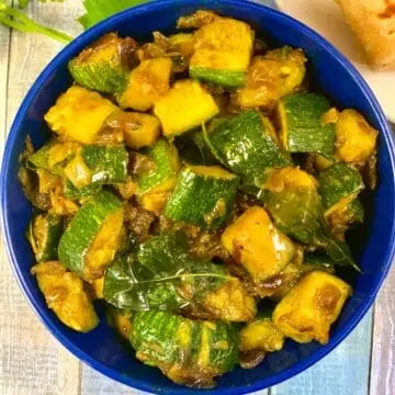 Zucchini Sabzi served in a bowl with chapati on side