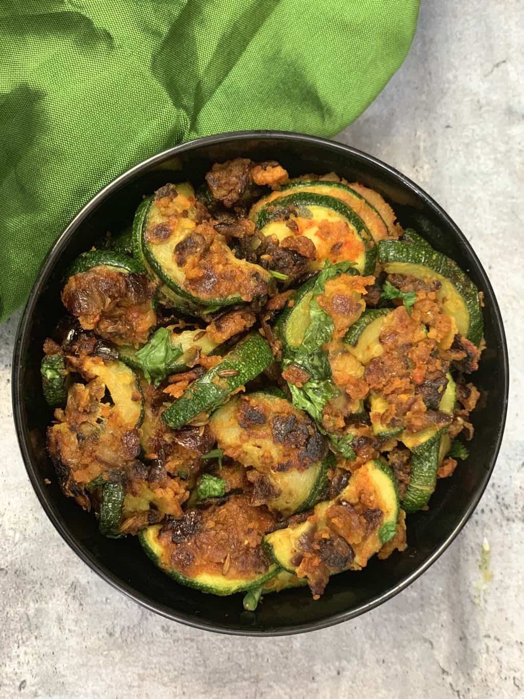 zucchini besan sabzi served in a bowl