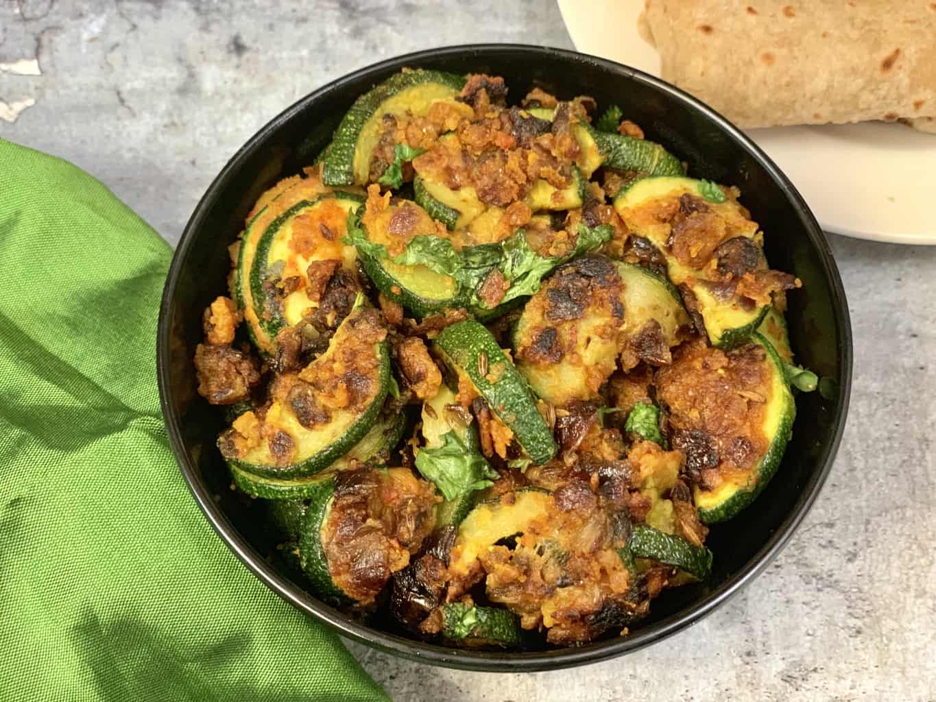 zucchini sabji in a bowl garnished with cilantro