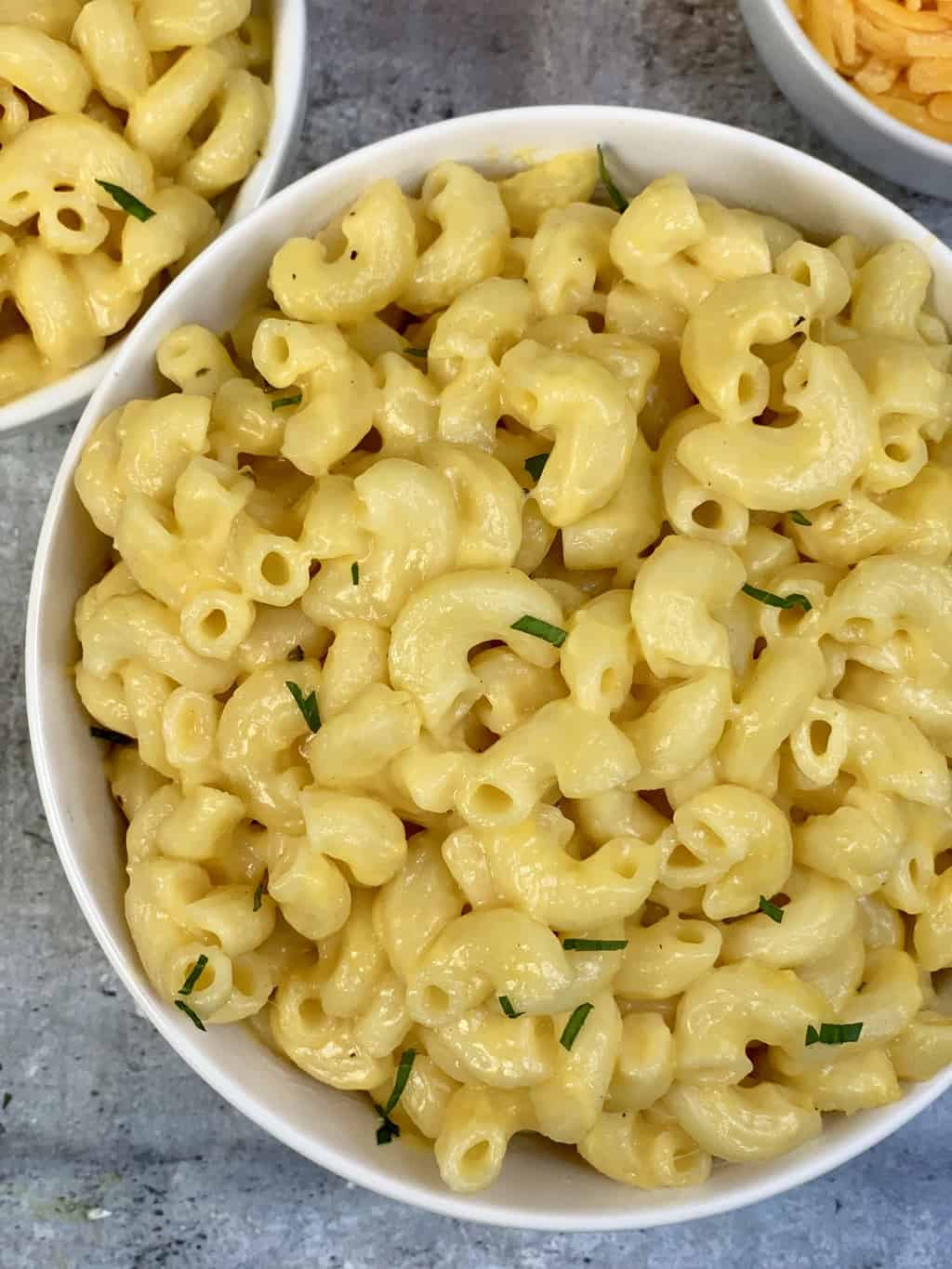 mac and cheese served in a bowl with sharp cheddar on the side