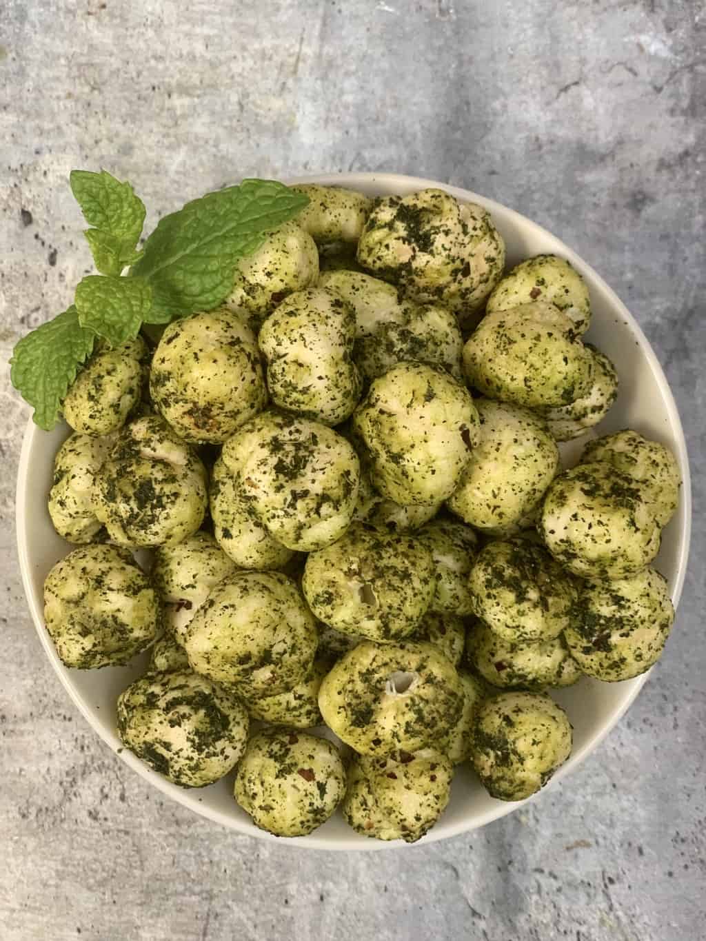 mint makhana served in a bowl with mint leaves on top