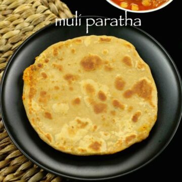 Mooli paratha served on a plate with chole curry on the side.