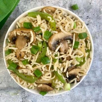 Mushroom Fried Rice served in a bowl garnished with green onions