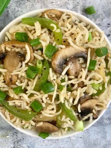 Mushroom Fried Rice served in a bowl garnished with green onions