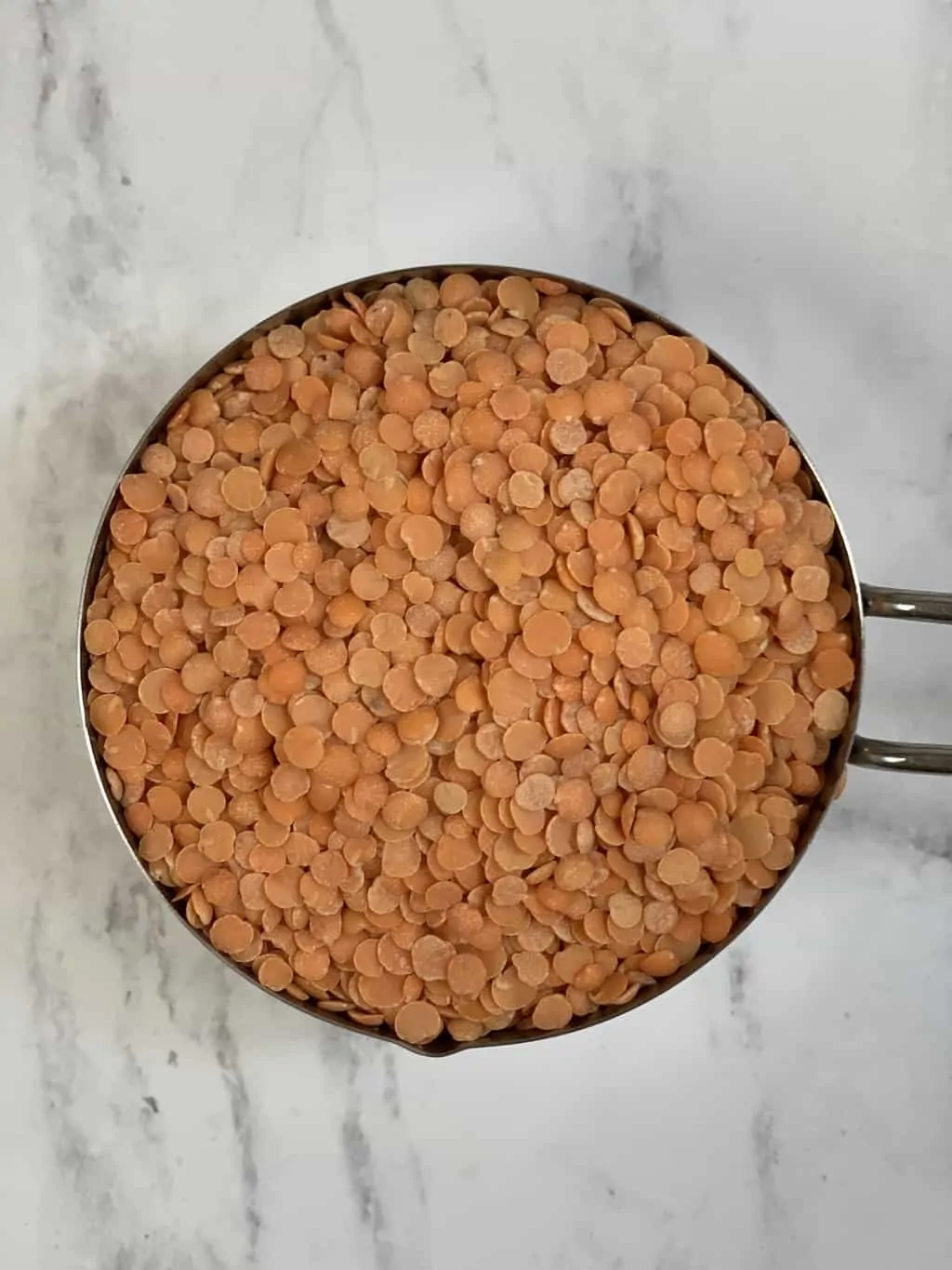 red lentils in a measuring cup