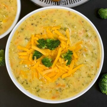 Instant Pot Broccoli Cheddar Cheese Soup served in a bowl garnished with cheddar soup and broccoli