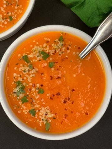 carrot ginger soup served in a white bowl
