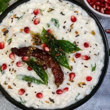 south indian curd rice served in a bowl with tempering on top and garnished with pomegranate