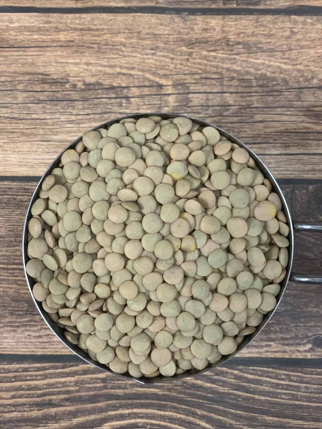 Green Lentils in a measuring cup