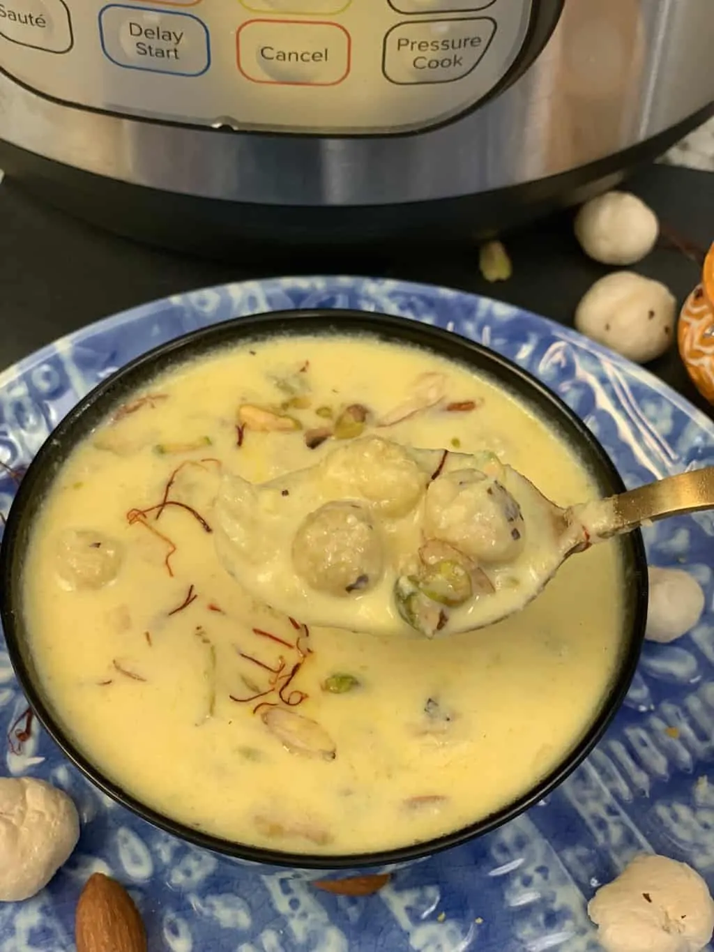 Phool Makhana Kheer served in a bowl with instant pot on the side