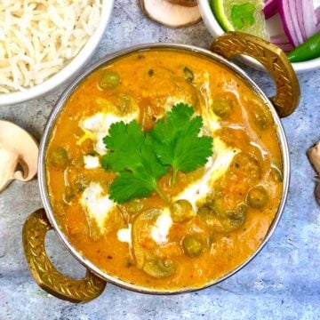 Mushroom Matar Masala served in a kadai with side of steamed rice