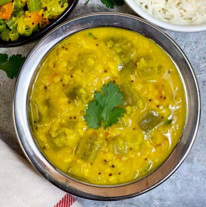 ridge gourd dal served in a bowl with poriyal and rice on the side
