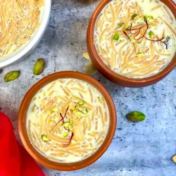 Semiya payasam served in two mud pots garnished with pistachios and saffron strands