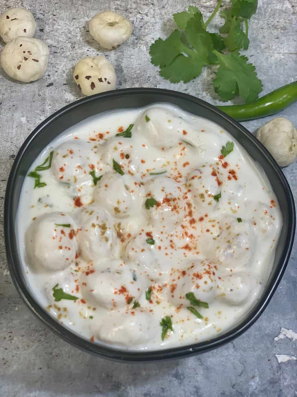 yogurt dip served in a bowl garnished with cilantro 