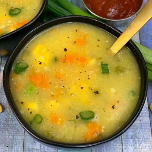 Sweet Corn Soup served in black bowl and ketchup on side