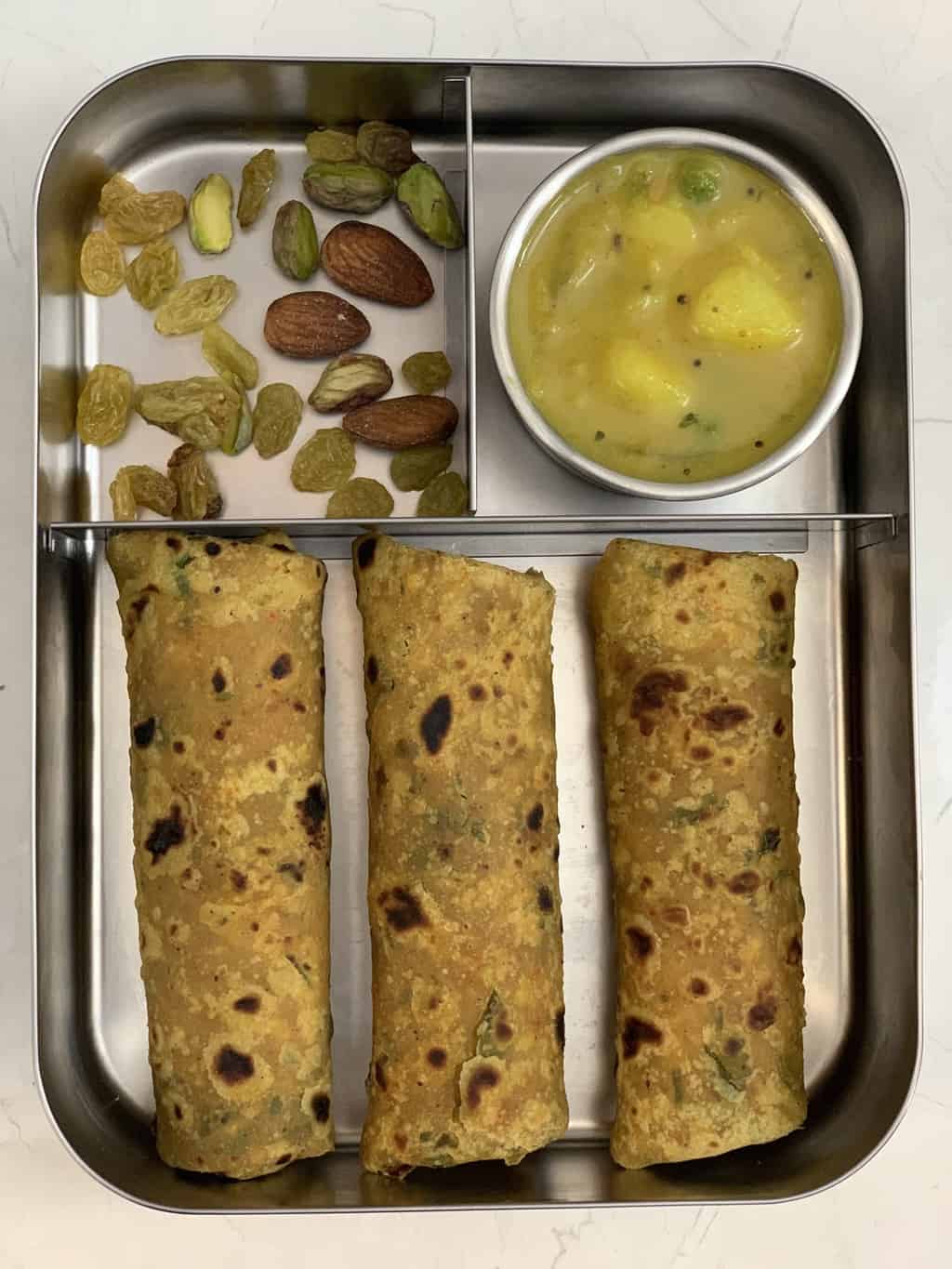 makhana paratha in kids lunch box with potato curry and nuts