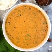 Peanut Samba served in a bowl with side of steamed rice and pickle