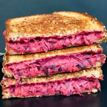 a stack of grilled beetroot carrot sandwich on a plate