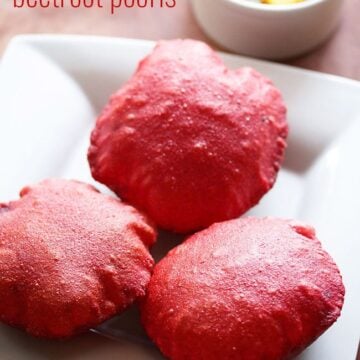 Three Beetroot poori served on a plate with aloo sabzi on the side.