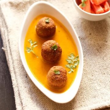 lauki kofta curry served in a bowl with carrot on the side.