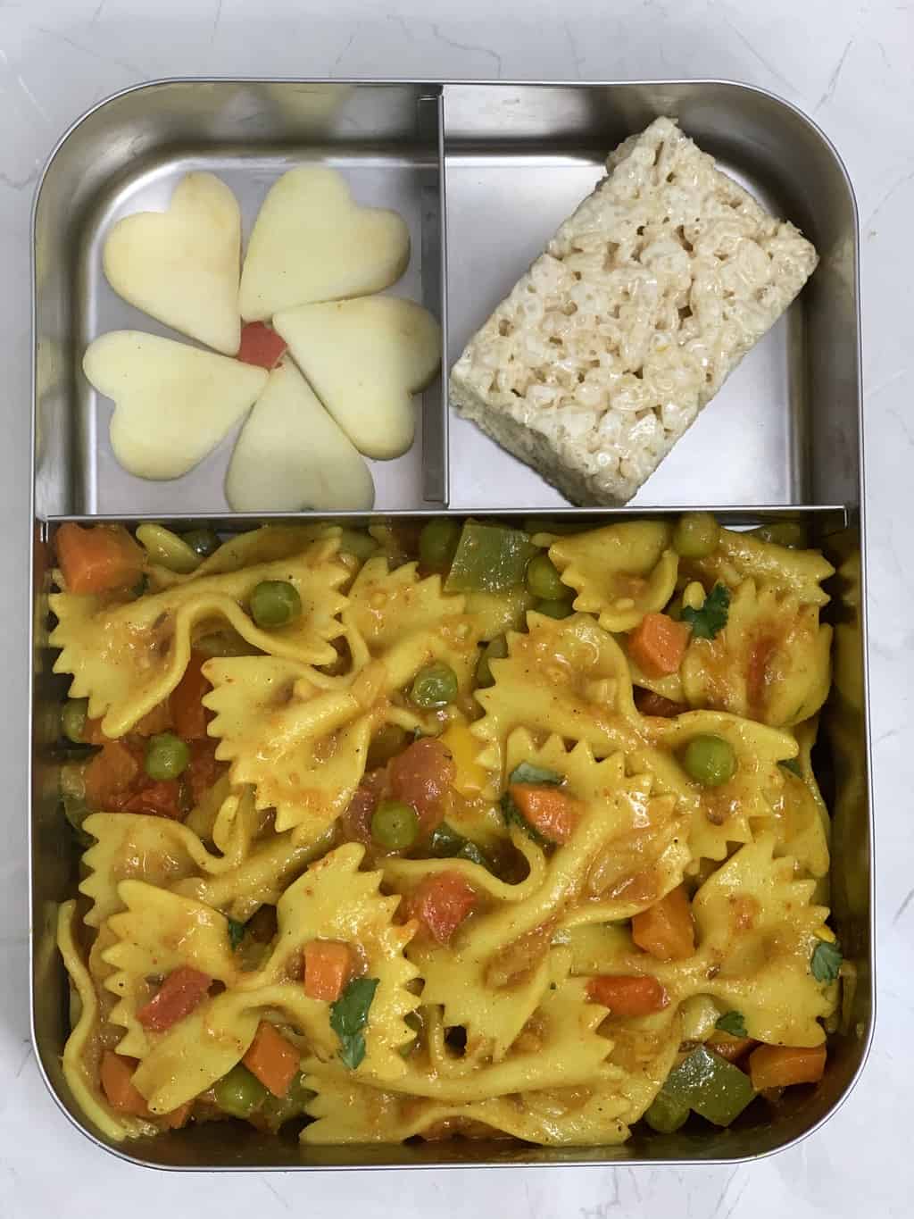 Masala Pasta, Rice Krispies and Apple in steel bento box.