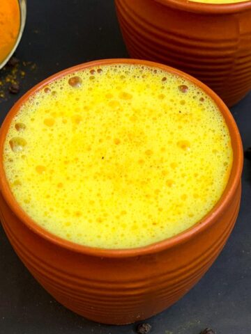 Turmeric golden milk (haldi doodh) served in a mud serving glass
