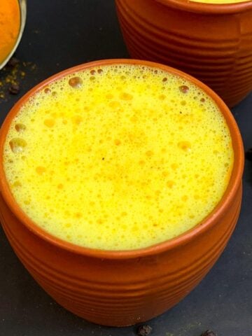 Turmeric golden milk (haldi doodh) served in a mud serving glass