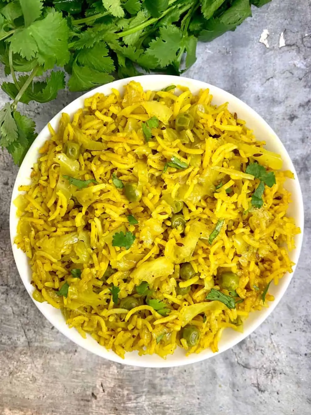cabbage rice served in a bowl garnished with cilantro