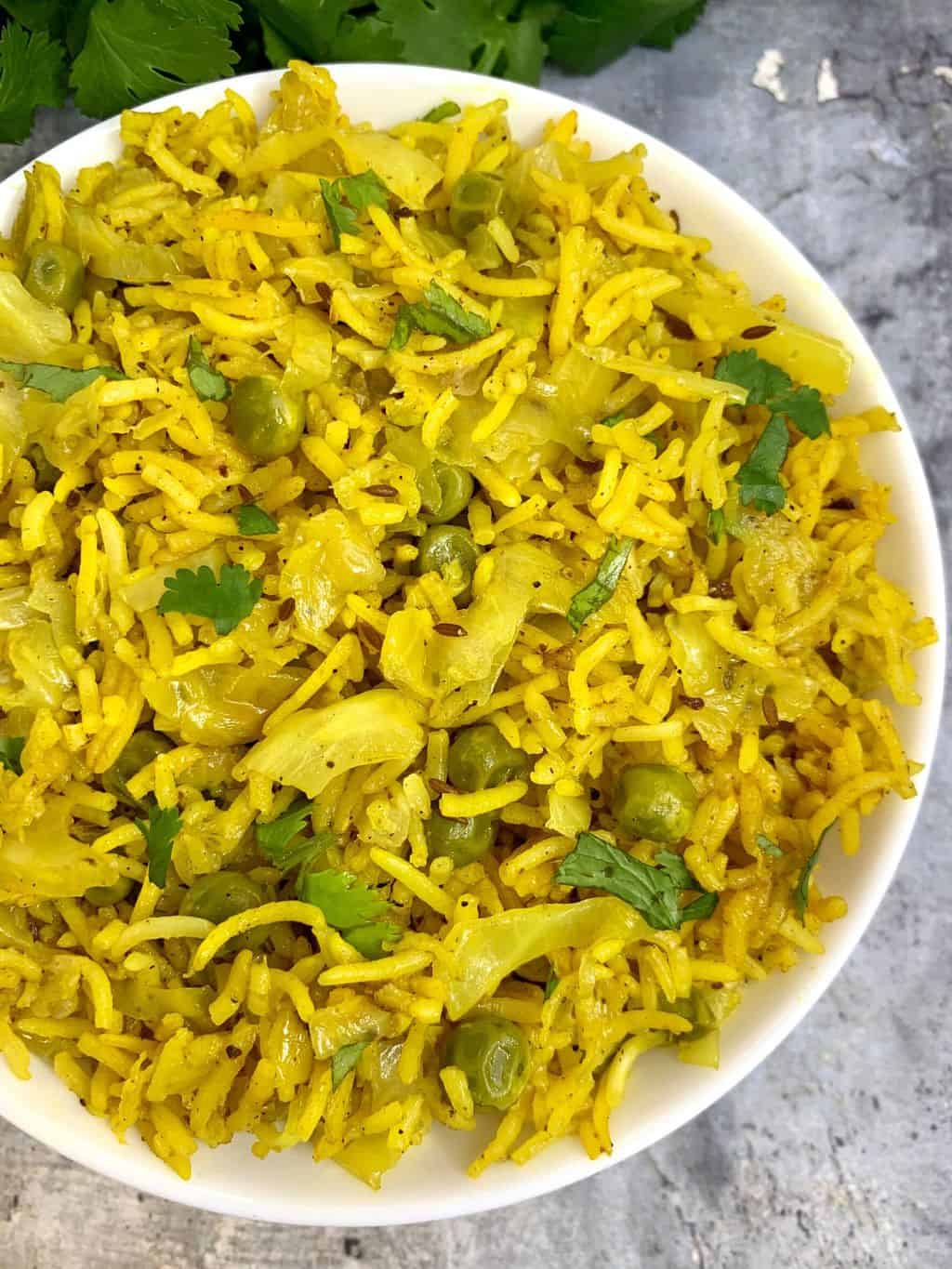 cabbage rice served in a bowl garnished with cilantro