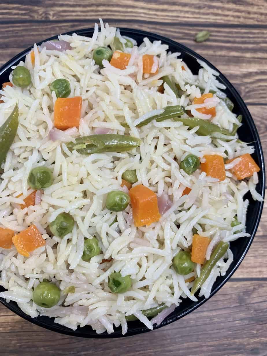 coconut milk pulao served in a black serving bowl