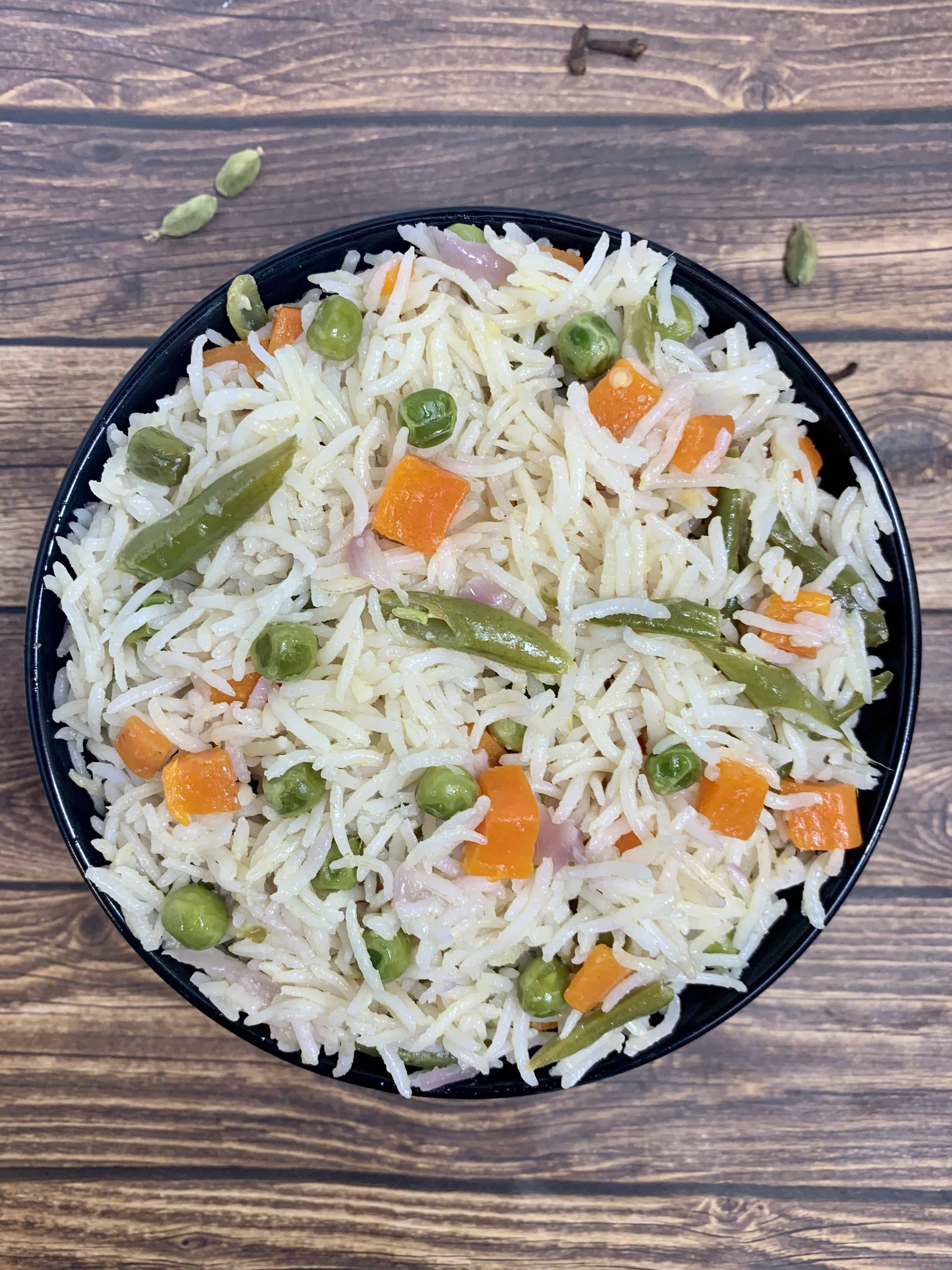 coconut milk pulao served in a black bowl