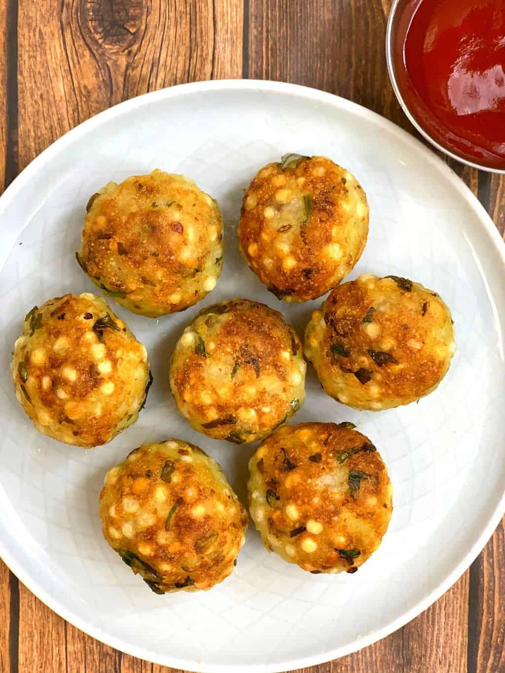 appe pan sabudana vada served in a plate served with ketchup