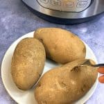 boil russet potatoes on a plate with a fork and instant pot on the side