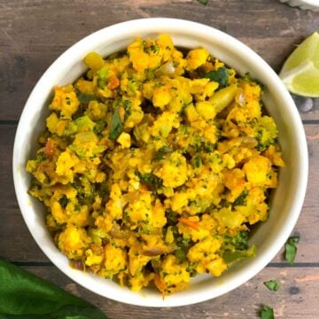 Broccoli Paneer Bhurji served in a white bowl with lemon wedge on side