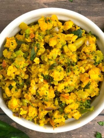 Broccoli Paneer Bhurji served in a white bowl with lemon wedge on side