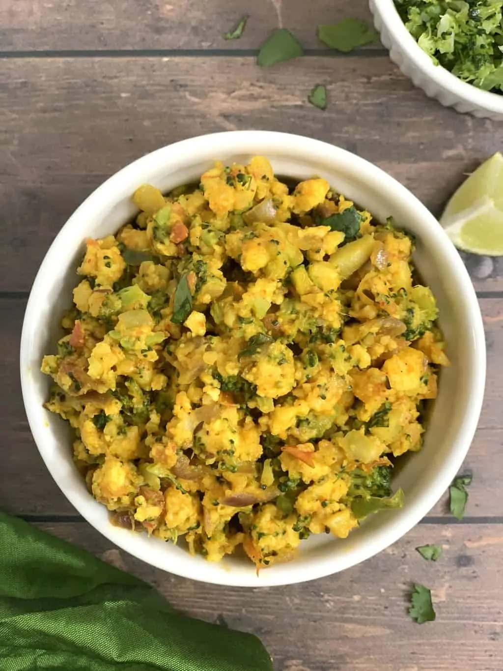 broccoli paneer bhurji served in a bowl with lemon wedge on the side