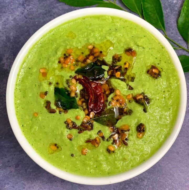 Green Coriander Coconut Chutney served in a bowl with tempering on top