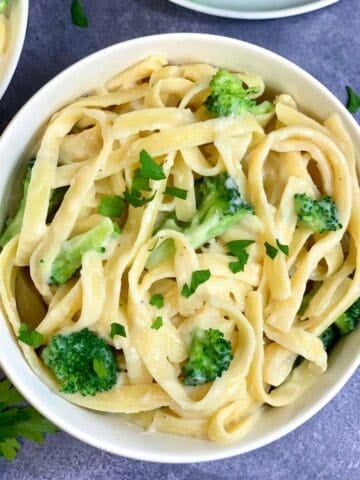 Instant Pot Fettuccini broccoli Alfredo served in a bowl garnished with parsley