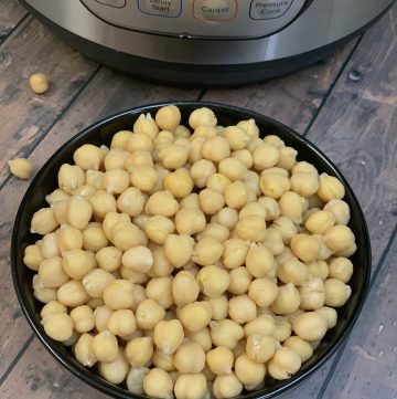 cooked chickpeas in a bowl and instant pot on the side
