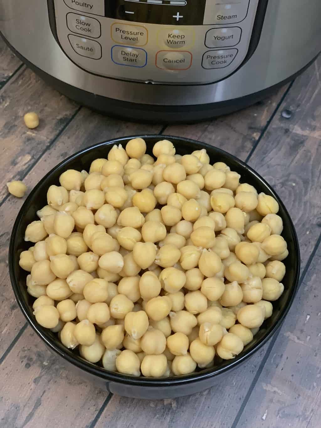 cooked chickpeas in a bowl and instant pot on the side